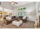 Inviting living room featuring large windows, plush seating, fireplace, and vaulted ceiling at 1006 Amberton Ln, Powder Springs, GA 30127