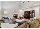 Comfortable living room with a stone fireplace, built-in shelving, and plush sectional seating at 1006 Amberton Ln, Powder Springs, GA 30127