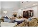 Comfortable living room with a stone fireplace, plush seating, and a large display cabinet at 1006 Amberton Ln, Powder Springs, GA 30127