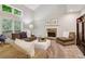 Spacious living room features a stone fireplace, neutral paint colors, and bright windows at 1006 Amberton Ln, Powder Springs, GA 30127