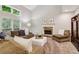 Spacious living room features a stone fireplace, plush seating, and large windows at 1006 Amberton Ln, Powder Springs, GA 30127