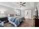 This main bedroom features a tray ceiling, carpeted floors, and an ensuite bathroom at 1006 Amberton Ln, Powder Springs, GA 30127