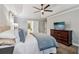 Spacious main bedroom with neutral tones, a ceiling fan, and an adjacent sitting area at 1006 Amberton Ln, Powder Springs, GA 30127