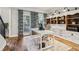 Office with built-in shelves, neutral walls, patterned drapes and rug, adjacent to stairs at 1006 Amberton Ln, Powder Springs, GA 30127