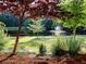Scenic view of a community pond with a fountain, surrounded by trees and landscaped grounds at 1006 Amberton Ln, Powder Springs, GA 30127