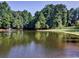 A serene community pond surrounded by lush greenery and a fountain, creating a peaceful ambiance at 1006 Amberton Ln, Powder Springs, GA 30127