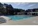 Large community pool with surrounding lounge chairs and covered pergola area for relaxation at 1006 Amberton Ln, Powder Springs, GA 30127