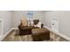 Attic bonus room features neutral paint, a brown loveseat and matching ottoman at 1006 Amberton Ln, Powder Springs, GA 30127