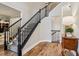 Carpeted staircase with elegant black railings at 1006 Amberton Ln, Powder Springs, GA 30127