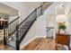 Carpeted Stairway with decorative banister leads to second floor of neutral toned and updated home at 1006 Amberton Ln, Powder Springs, GA 30127