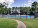 Community tennis courts surrounded by a black fence and lush greenery, offering recreational opportunities at 1006 Amberton Ln, Powder Springs, GA 30127