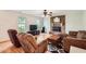 Inviting living room with a cozy fireplace, hardwood floors, and plenty of natural light at 1739 Brandy Woods Se Trl, Conyers, GA 30013