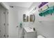 This bathroom includes white cabinets, an oval mirror, and decorative lighting fixtures at 3428 Ivys Walk, Atlanta, GA 30340