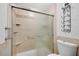 This bathroom features a tiled shower with glass doors and modern fixtures at 3428 Ivys Walk, Atlanta, GA 30340