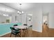 Open dining room showcases updated lighting, wall mirror, and hardwood flooring at 3428 Ivys Walk, Atlanta, GA 30340