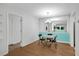 Dining room with mirror wall, unique lighting fixture, and hardwood flooring at 3428 Ivys Walk, Atlanta, GA 30340