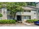 Attractive home exterior with mature trees, manicured bushes, and a convenient parking area at 3428 Ivys Walk, Atlanta, GA 30340