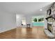 Comfortable living room featuring hardwood floors, a stone fireplace, and natural light at 3428 Ivys Walk, Atlanta, GA 30340
