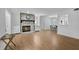 Spacious living room with a stone fireplace, hardwood flooring, and an open layout to the dining area at 3428 Ivys Walk, Atlanta, GA 30340