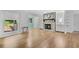 Bright living room with a stone fireplace, hardwood floors, and an open layout to the dining area at 3428 Ivys Walk, Atlanta, GA 30340