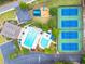 Aerial view of community amenities including a swimming pool, playground, tennis courts and parking at 570 Hunt River Way, Suwanee, GA 30024