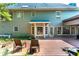 Back of house features a spacious deck, chairs, and a landscaped yard with greenery at 570 Hunt River Way, Suwanee, GA 30024