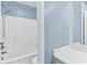 This bathroom features a shower/tub combo with a shower head and a vanity with a framed mirror at 570 Hunt River Way, Suwanee, GA 30024