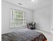 This bedroom features a window, carpet, and a desk area at 570 Hunt River Way, Suwanee, GA 30024