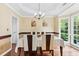 Bright dining room with a window for lots of natural light and a classic chandelier overhead at 570 Hunt River Way, Suwanee, GA 30024