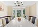 Bright dining room with a bay window and a large table for hosting elegant meals at 570 Hunt River Way, Suwanee, GA 30024