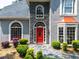Charming home with a red door, stone accents and manicured landscaping creating a welcoming entrance at 570 Hunt River Way, Suwanee, GA 30024