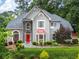 Beautiful home with well-maintained landscaping, a red door and stone accents for added charm at 570 Hunt River Way, Suwanee, GA 30024