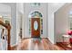 Grand foyer with hardwood flooring, a decorative front door and sidelights for a welcoming entrance at 570 Hunt River Way, Suwanee, GA 30024