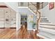 Inviting foyer featuring hardwood floors, a staircase, and open access to other rooms at 570 Hunt River Way, Suwanee, GA 30024