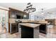 Well-lit kitchen featuring an island, granite countertops, stainless steel appliances, and dark cabinets at 570 Hunt River Way, Suwanee, GA 30024