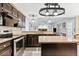 Spacious kitchen with granite countertops, black cabinetry, and stainless steel appliances at 570 Hunt River Way, Suwanee, GA 30024