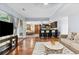 Open floor plan with living room, kitchen, and dining areas creating a welcoming and cohesive living space at 570 Hunt River Way, Suwanee, GA 30024