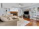 Inviting living room with cozy fireplace, built-in bookshelves, and comfortable sectional sofa at 570 Hunt River Way, Suwanee, GA 30024