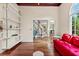 Bright living room featuring hardwood floors, built-in shelves and a view to a beautiful staircase at 570 Hunt River Way, Suwanee, GA 30024