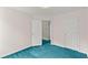 Bedroom with two doors visible and light walls over blue carpeting at 2806 Vintage Wood Nw Way, Kennesaw, GA 30144