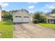 View of the front of the house featuring a two-car garage, driveway, and a lawn with healthy green grass at 2806 Vintage Wood Nw Way, Kennesaw, GA 30144