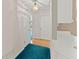 Bright hallway featuring wood floors and a vibrant area rug, leading to other rooms in the home at 2806 Vintage Wood Nw Way, Kennesaw, GA 30144