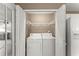 Bright laundry area featuring a washer and dryer with wire shelving for storage at 2806 Vintage Wood Nw Way, Kennesaw, GA 30144
