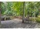 Cozy back deck overlooking a green forested area with a metal table and chairs at 3009 Gant Quarters Dr, Marietta, GA 30068