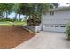 Side of the home featuring a ground-level garage and stairs leading to the backyard at 3009 Gant Quarters Dr, Marietta, GA 30068