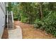 View of a lush backyard with trees and stairs leading up to a deck at 3009 Gant Quarters Dr, Marietta, GA 30068