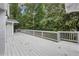 Backyard deck is spacious with white railing and beautiful greenery surrounding at 3009 Gant Quarters Dr, Marietta, GA 30068