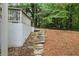 Landscaped backyard with stone steps leading up to the side of the house at 3009 Gant Quarters Dr, Marietta, GA 30068