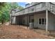 Exterior of the home with a deck and patio area surrounded by mature trees at 3009 Gant Quarters Dr, Marietta, GA 30068
