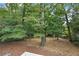 A treed backyard lot with a covering of fallen leaves at 3009 Gant Quarters Dr, Marietta, GA 30068